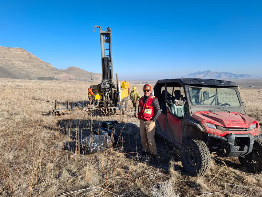 Core drilling rig with a surveyor on a remote desert exploration site