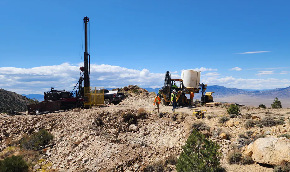 Large core drilling rig on a rocky hillside in desert landscape