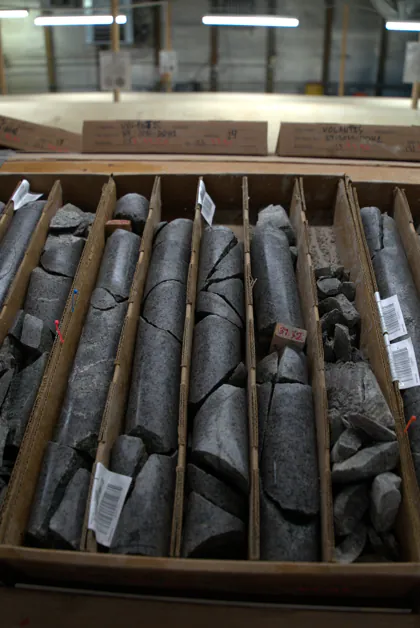 Rock core samples organised and labelled in wooden storage boxes in a laboratory